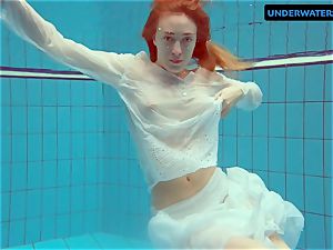 red-haired Diana warm and wild in a milky dress
