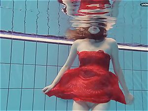 red clad nubile swimming with her eyes opened