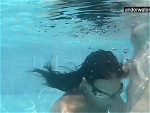 submerged underwater with a man sausage inwards her